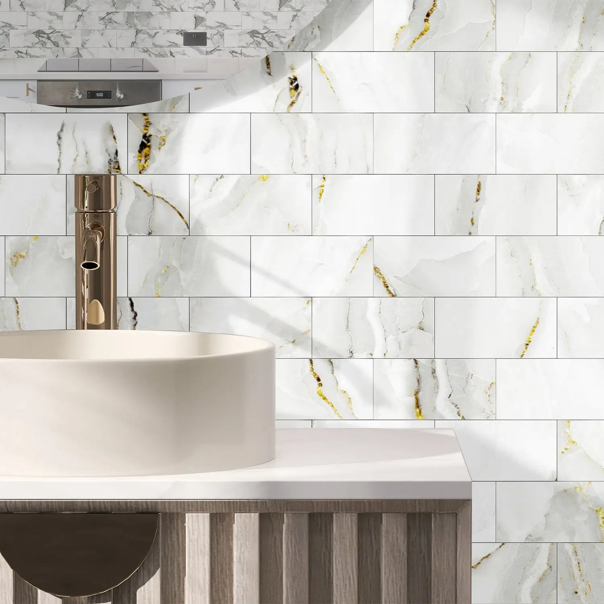 A modern bathroom vanity featuring a white vessel sink and marble-patterned wall tiles.