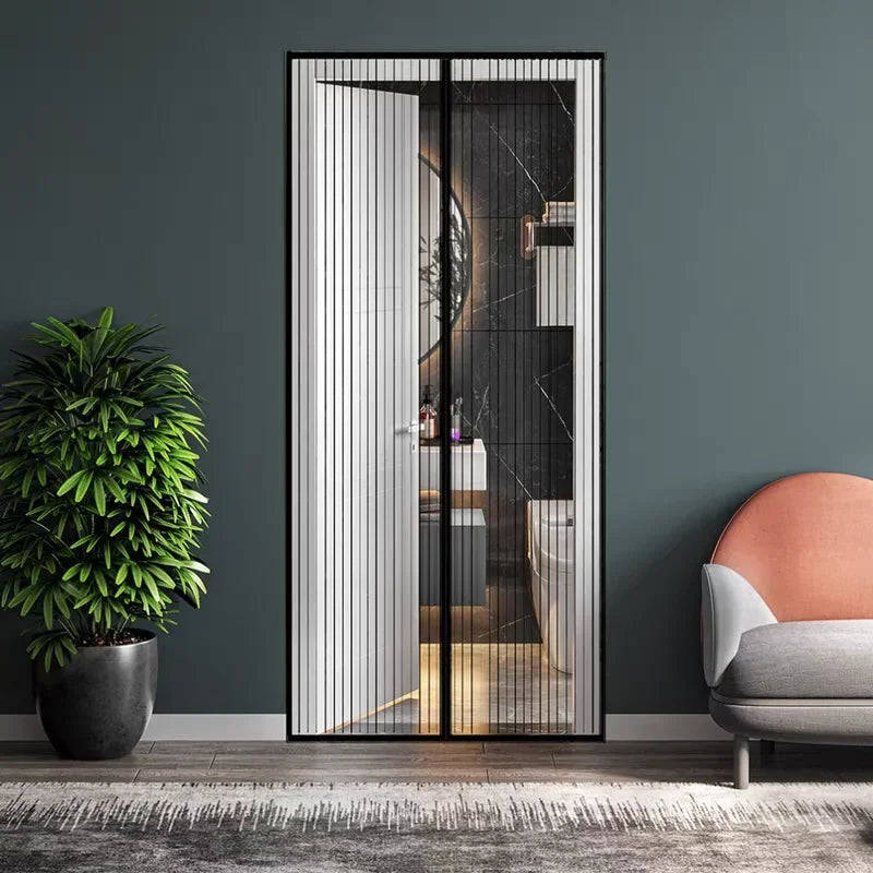A modern glass door with vertical slats showing an interior space and a potted plant in the foreground.