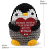 A handmade crochet penguin doll with a heart-shaped card that reads When penguins find their mate they stay together forever.