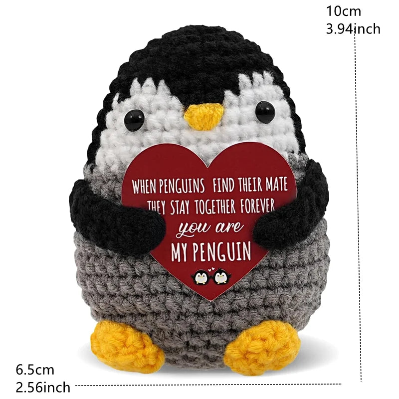 A handmade crochet penguin doll with a heart-shaped card that reads When penguins find their mate they stay together forever.