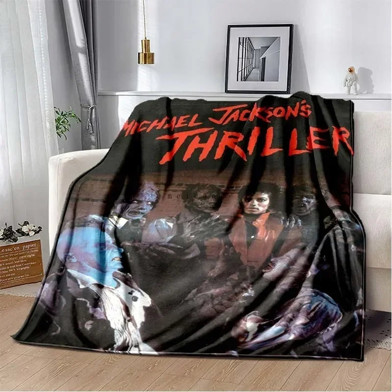 A black and red graphic print featuring Michael Jackson's thriller title on a flannel throw blanket.