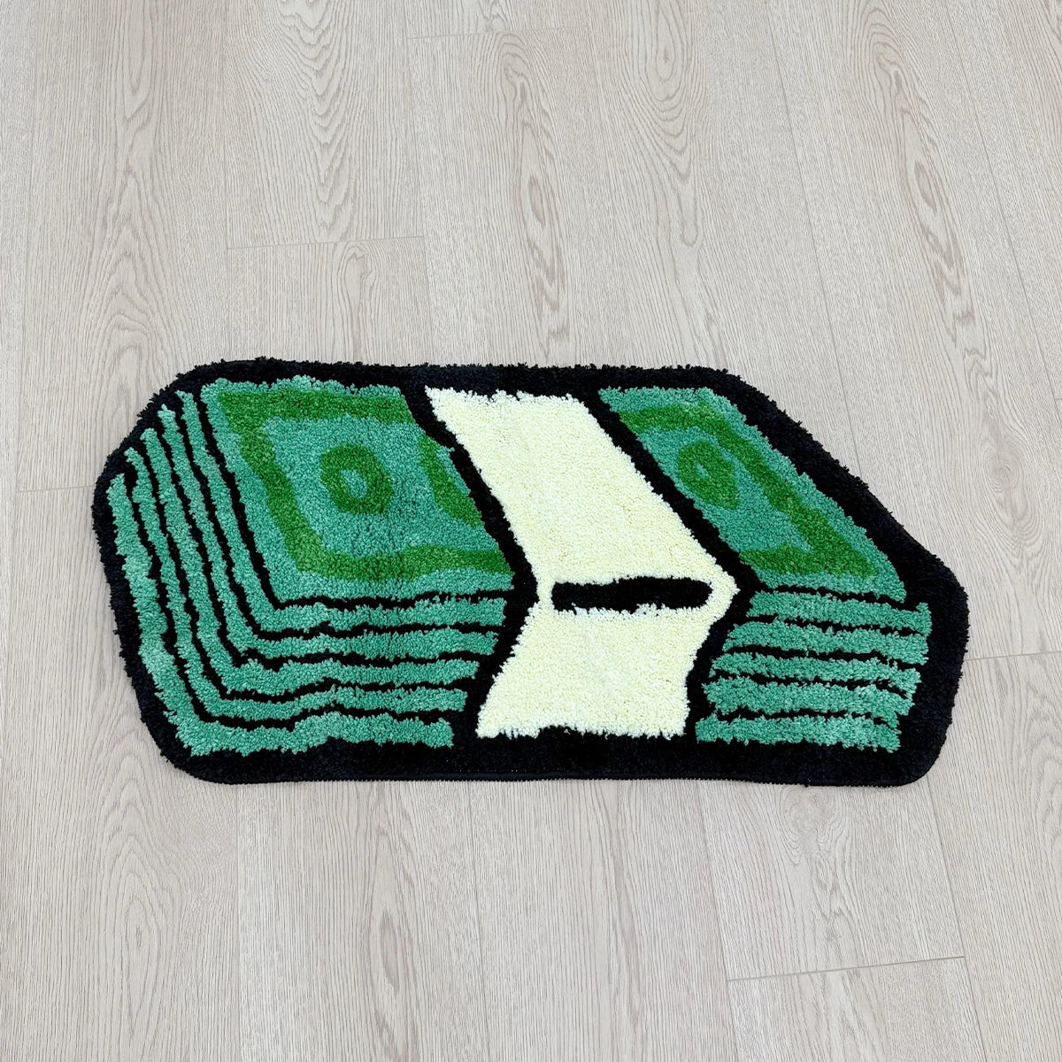 A rectangular mat featuring a green dollar bill design with a white cutout, used for bathroom or entryway
