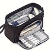 A black double-deck canvas pencil case filled with various writing tools and stationery.