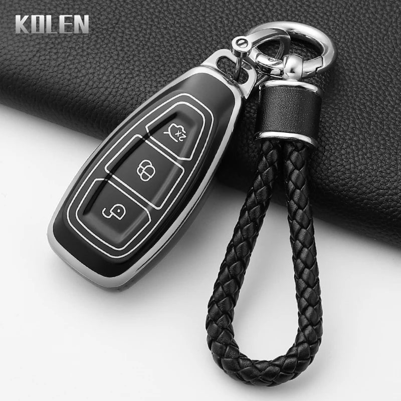 A black silicone car key fob cover with a silver clip and black braided lanyard.