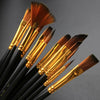 A collection of twelve black brush handles with golden ferrules and various sized nylon bristles for painting.
