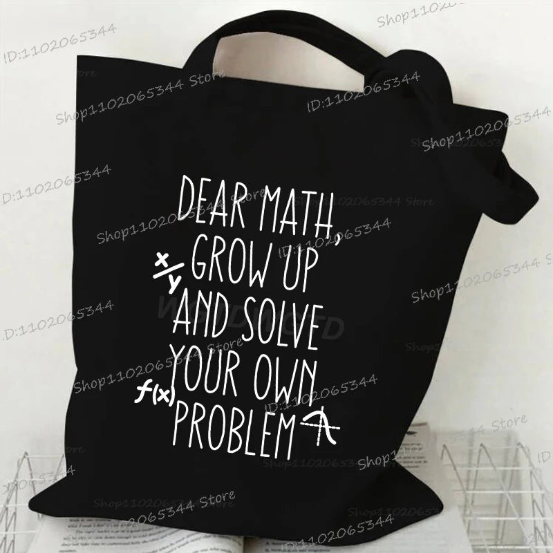 Black canvas tote bag with white text that reads Dear Math Grow Up and Solve Your Own Problem