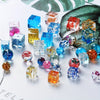 Assortment of colorful crystal ball beads and geometric silicone molds for DIY jewelry making