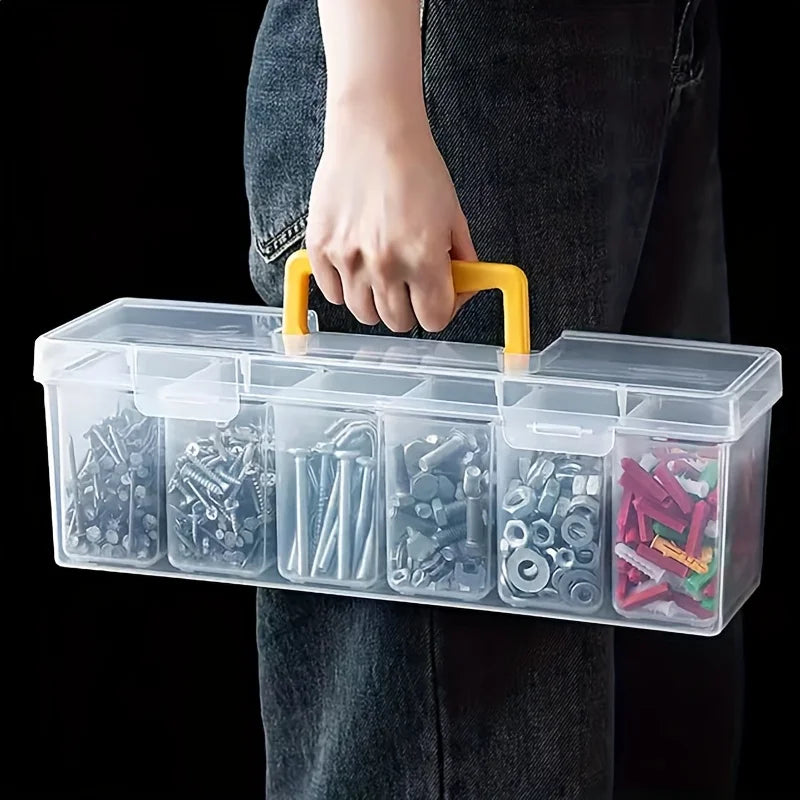 A hand holds a clear plastic multi-compartment storage box filled with various hardware and tools.