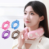 A woman holds various colored U-shaped reusable neck wraps, including pink, blue, purple, and gray, against her neck.