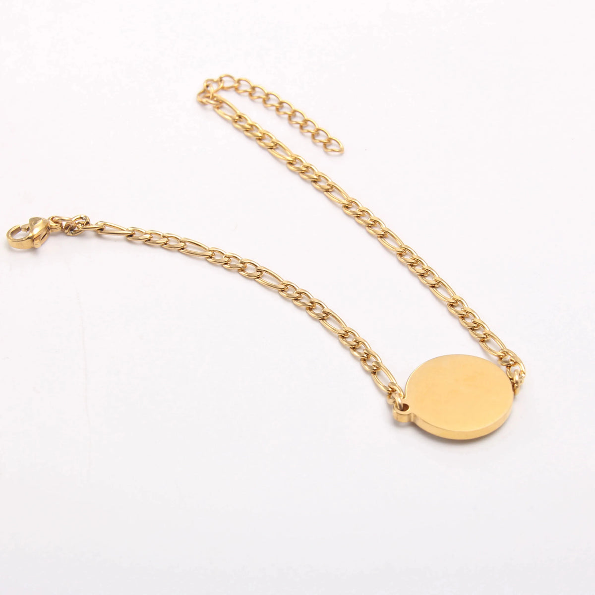 A gold-toned stainless steel initial letter bracelet with a circular charm and a chain.