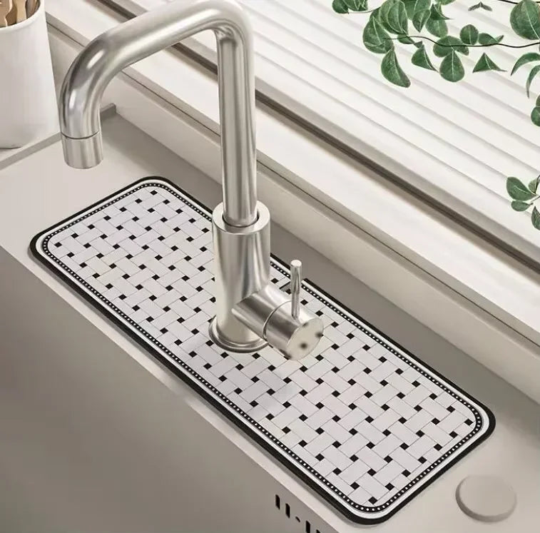 A modern chrome faucet mounted on a square white mat with black grid lines, set in a bathroom sink.