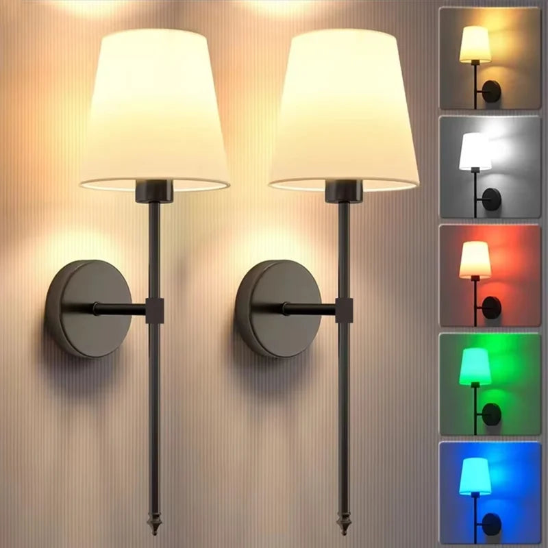 A set of modern wall lamps with adjustable shades and remote controls mounted on a textured wall.
