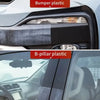 Close-up view of car bumper plastic and B-pillar plastic components being restored or coated.