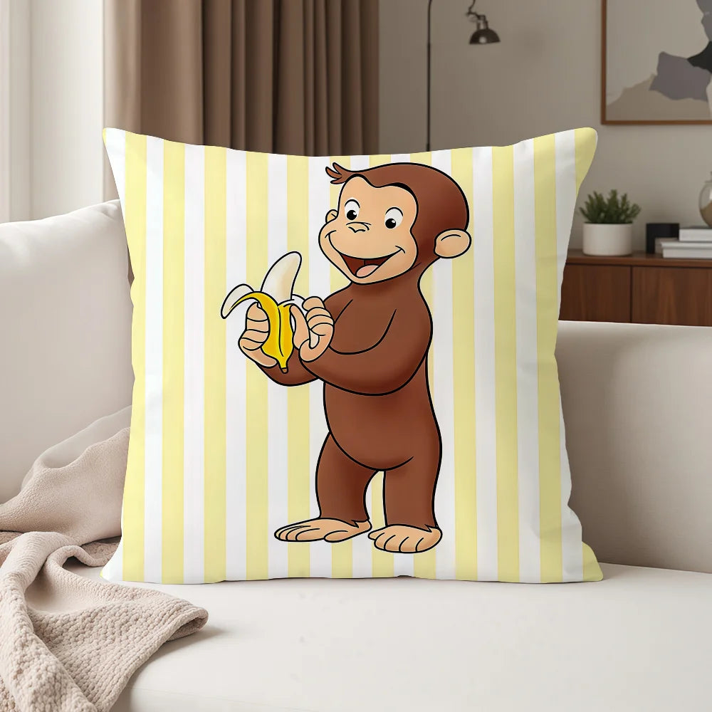 A yellow and white striped pillow featuring a cartoon monkey character, Curious George.