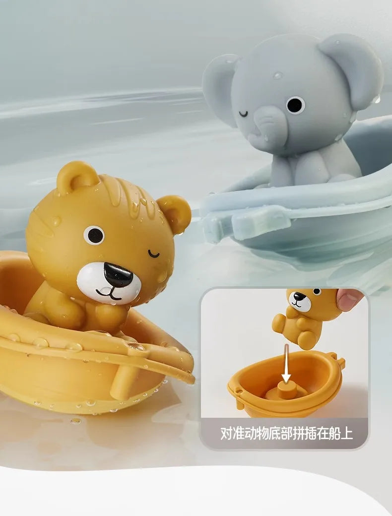 A set of soft silicone bath toys featuring a yellow lion and a gray elephant floating in water.