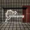 A white neon sign shaped like the map of Nuremberg is displayed in a grid pattern against a dark background.