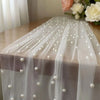 Sheer tulle table runner adorned with small pearl beads for weddings and events