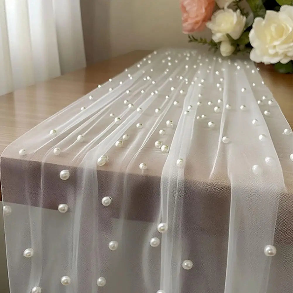 Sheer tulle table runner adorned with small pearl beads for weddings and events