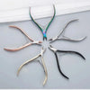 A collection of professional stainless steel cuticle nippers in various colors and angles.