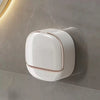A white waterproof hanging soap holder with drainage is mounted on a gray wall.