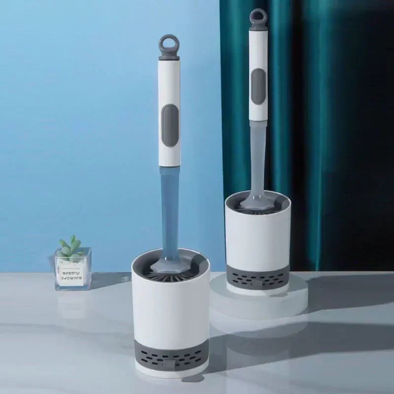 A white and blue refillable toilet brush set with a wall-mounted holder is displayed on a light surface.