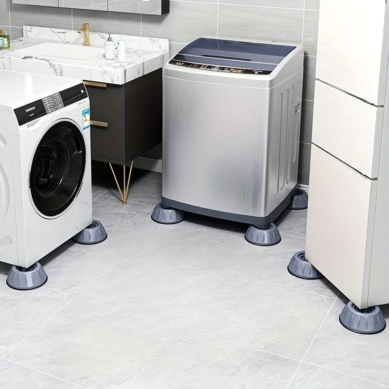 A white washing machine and a silver dryer are shown with anti-vibration pads on their feet in a kitchen setting.