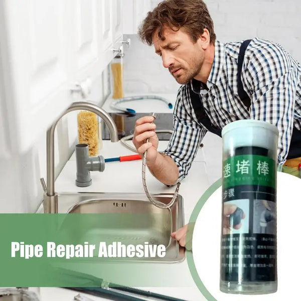 A man is using a tube of Pipe Repair Adhesive to fix a pipe under a kitchen sink.