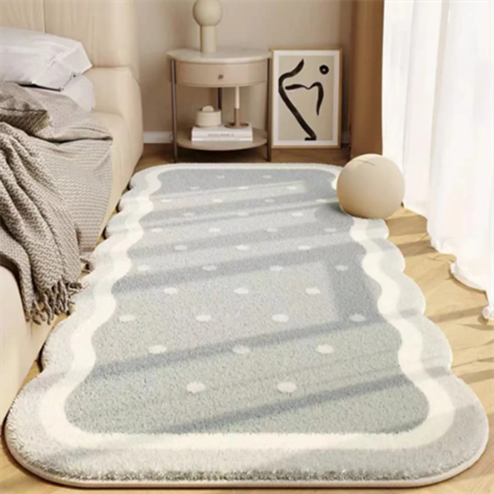 A plush gray decorative area rug with white polka dots and borders placed on a light wooden floor.