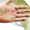 A hand is holding a sheer, light green mosquito net fabric.
