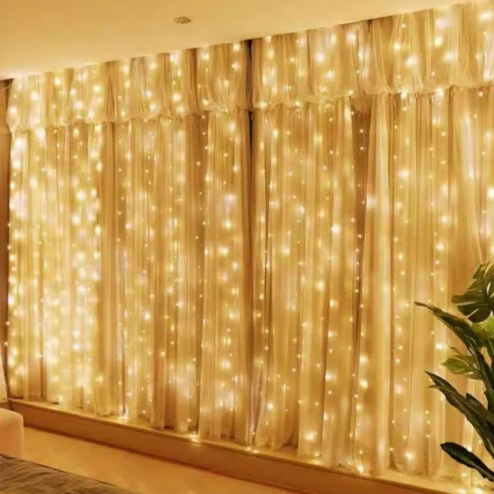 Golden sheer curtains illuminated by warm fairy lights creating a soft, glowing backdrop for home decor