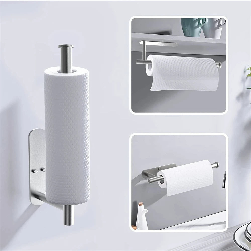 A stainless steel toilet paper holder with a roll of white paper towel displayed on a wall.