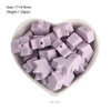 A pile of 19 lilac silicone crown star heart beads for DIY jewelry making