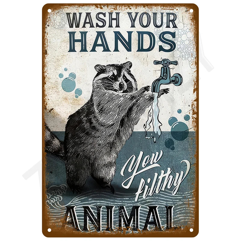 Vintage metal tin sign with text instructing to wash hands and featuring a raccoon illustration.