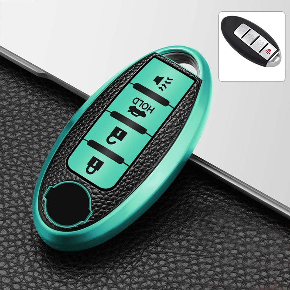 A teal TPU key fob cover with a black grip and multiple buttons is shown resting on a black textured surface.