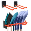 A heavy-duty wall-mounted garden tool organizer rack with black brackets and orange handles, holding several garden tools.