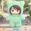 A soft green cat plush doll with a hood and human-like face is displayed outdoors on a wooden surface.