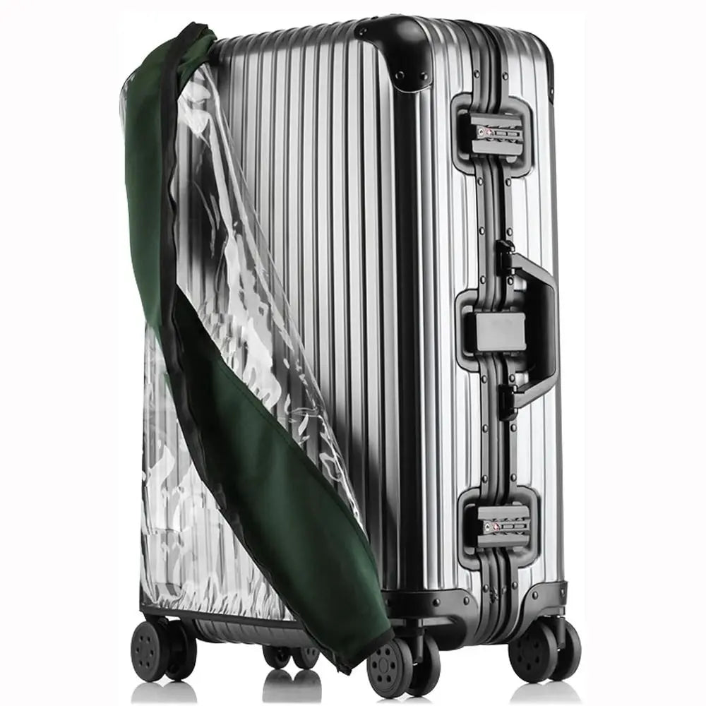 A silver suitcase with a transparent green waterproof cover draped over it.
