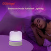 A white bedside ambient lighting product illuminates a woman resting in bed with purple lighting.