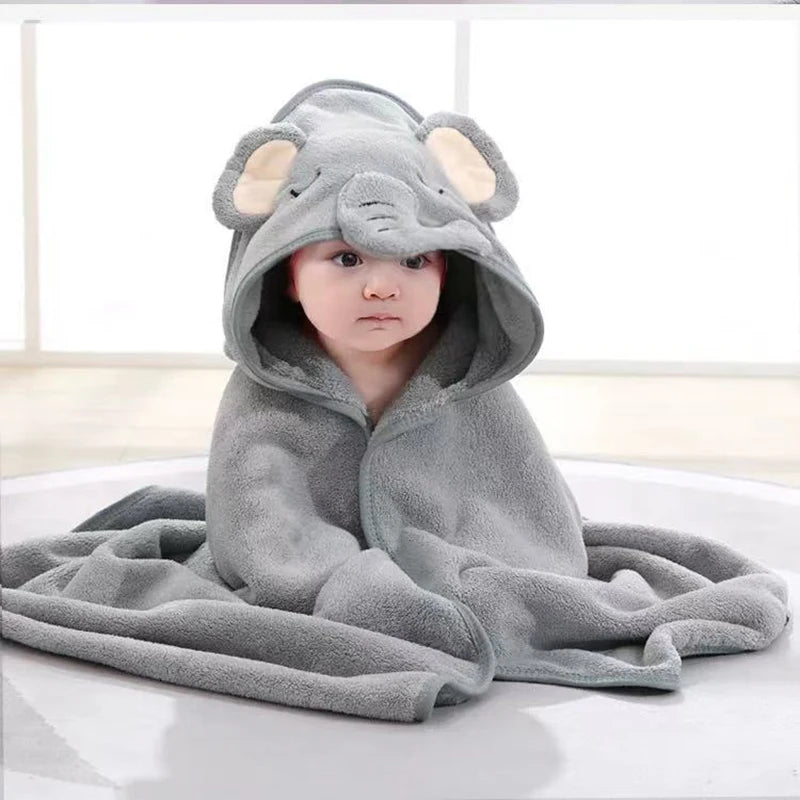 A baby wearing a gray hooded towel with an elephant face design