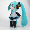 A soft teal plush doll of Hatsune Miku with long hair and a black outfit.