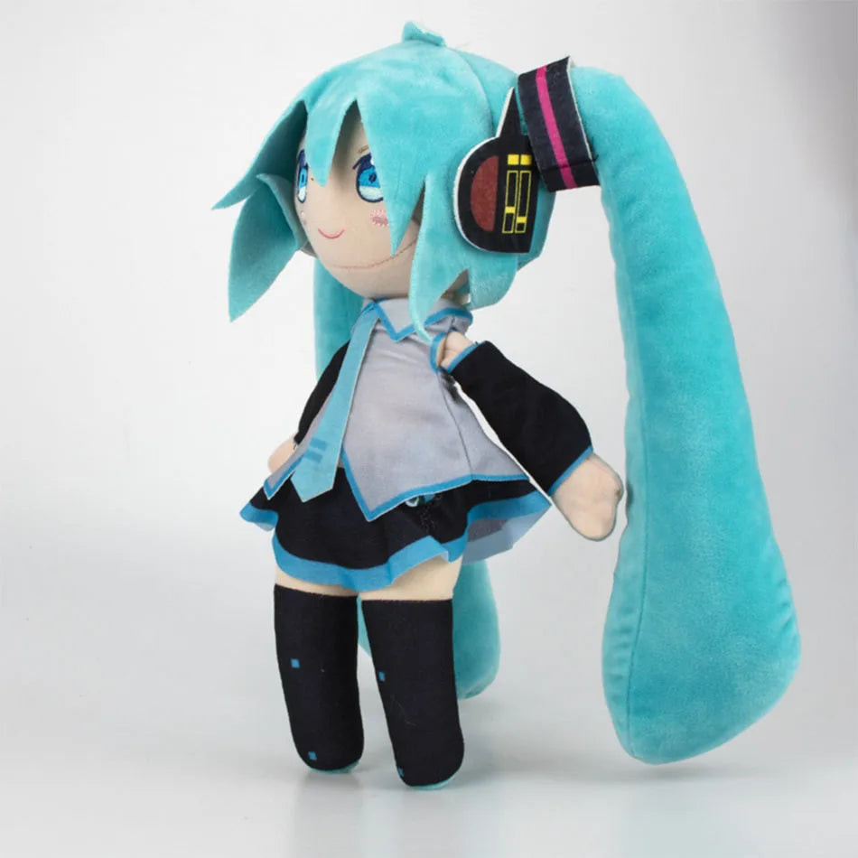 A soft teal plush doll of Hatsune Miku with long hair and a black outfit.