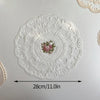 Elegant oval white lace embroidered placemat with a pink floral design