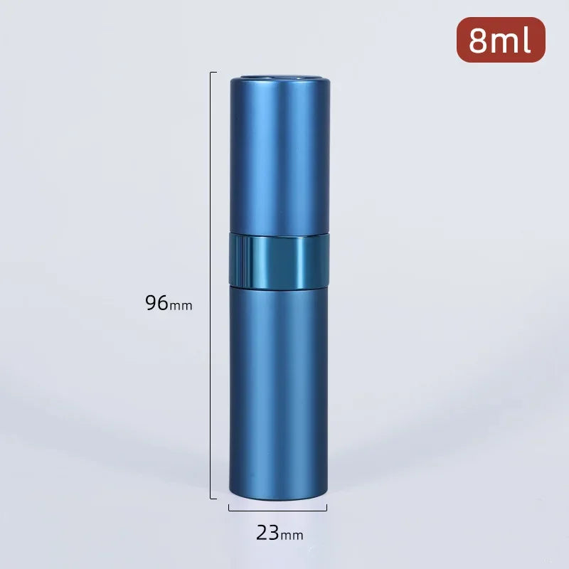 A tall, cylindrical blue aluminum perfume atomizer with a silver cap and a black band, shown against a light gray background.