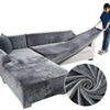 Gray plush velvet elastic sofa cover draped over an L-shaped sofa and a section of a standard sofa.
