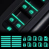 Close-up view of a black car window switch with glowing green LED indicators and a set of digital stickers.