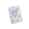 A white photo album cover with a heart cutout and small pink bear decorations.