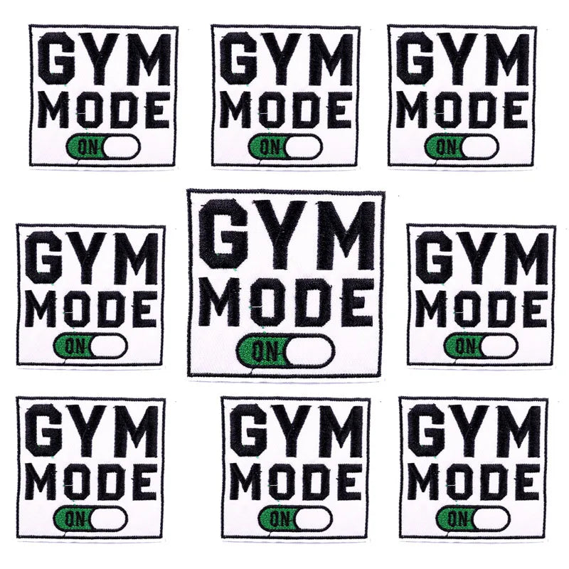 A set of ten embroidered gym mode iron-on patches featuring the text GYM MODE ON