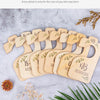A set of eight wooden baby closet dividers showing sizes from newborn to 18 months, arranged on a gray surface.