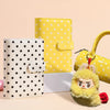 A yellow polka dot PU leather binder wallet with cash envelopes and card holder next to a white gift box.