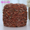 A ball of metallic silk crochet yarn with an orange and brown shimmer texture.